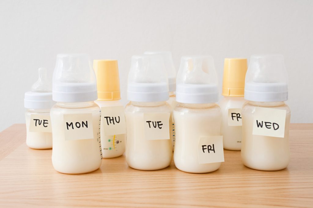 Baby bottles with days of the week on adhesive notes